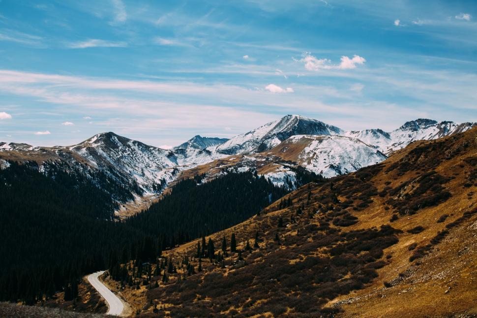 Free Image of Dirt Road Cutting Through Valley With Mountain Background 