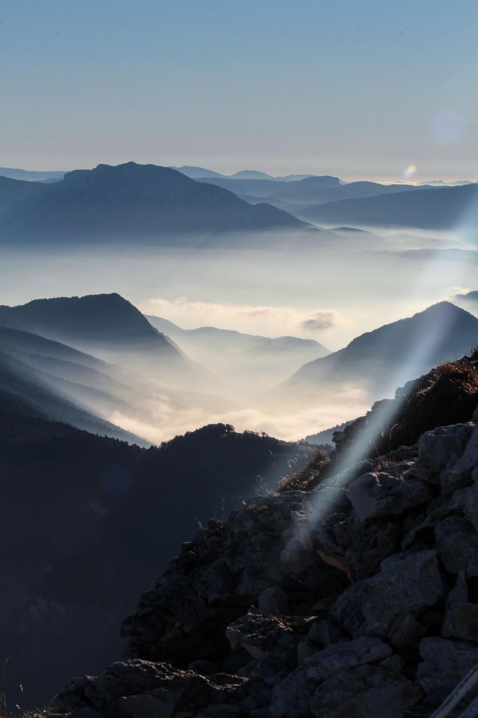 Free Image of Person Standing on Top of Mountain With Sky Background 