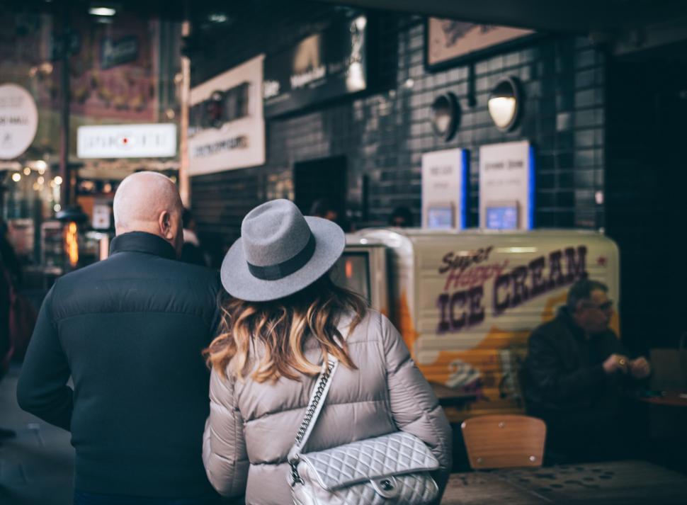 Free Image of A Man and a Woman Walking Down a Street 