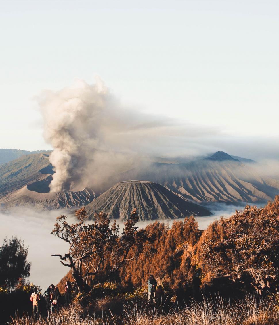 Free Image of Group of People Standing on Top of a Mountain 
