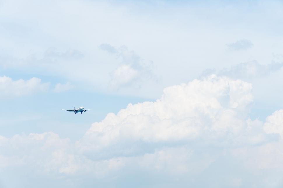 Free Image of Airplane Flying Through Cloudy Sky 