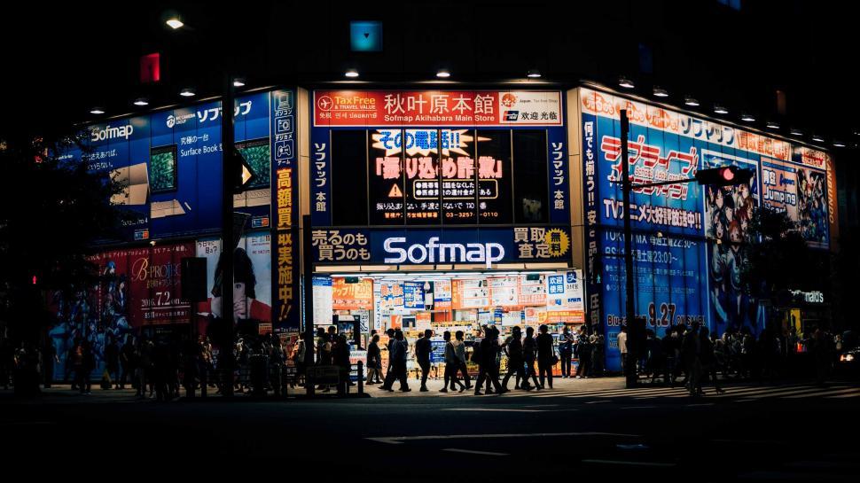 Free Image of Group of People Standing Outside Building at Night 