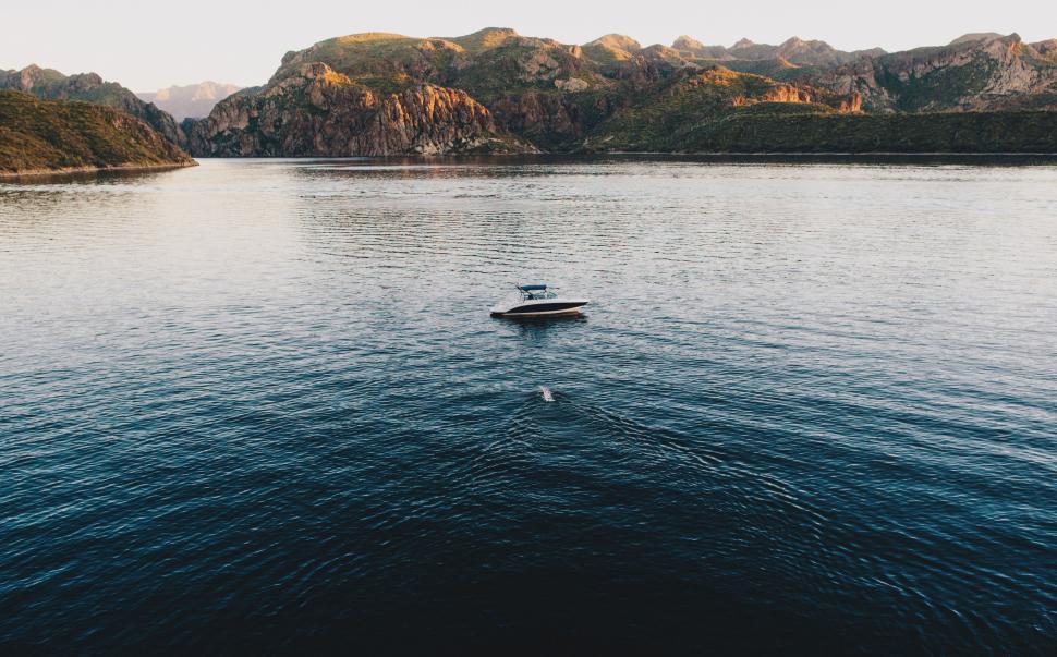 Free Image of Boat Floating on Large Body of Water 