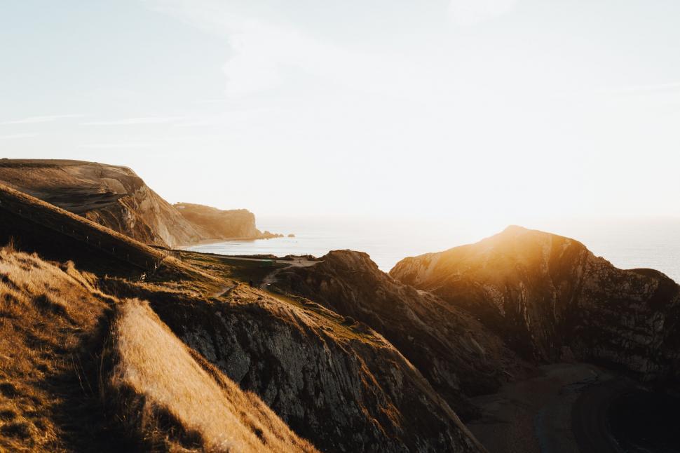 Free Image of Person Riding Bicycle on Trail Alongside Water 