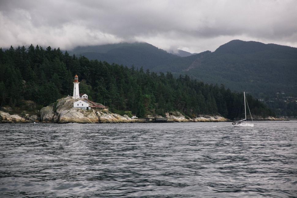 Free Image of Sailboat Sailing Near Lighthouse 