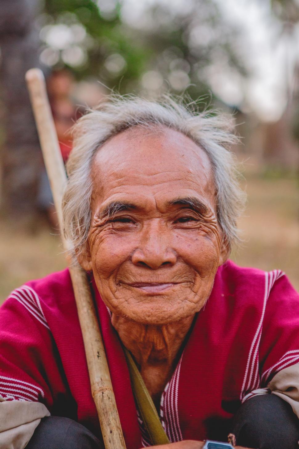 Free Image of Old Man Smiling While Holding Baseball Bat 