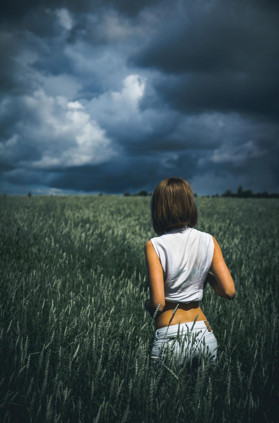 Free Image of Woman Standing in Tall Grass Field 