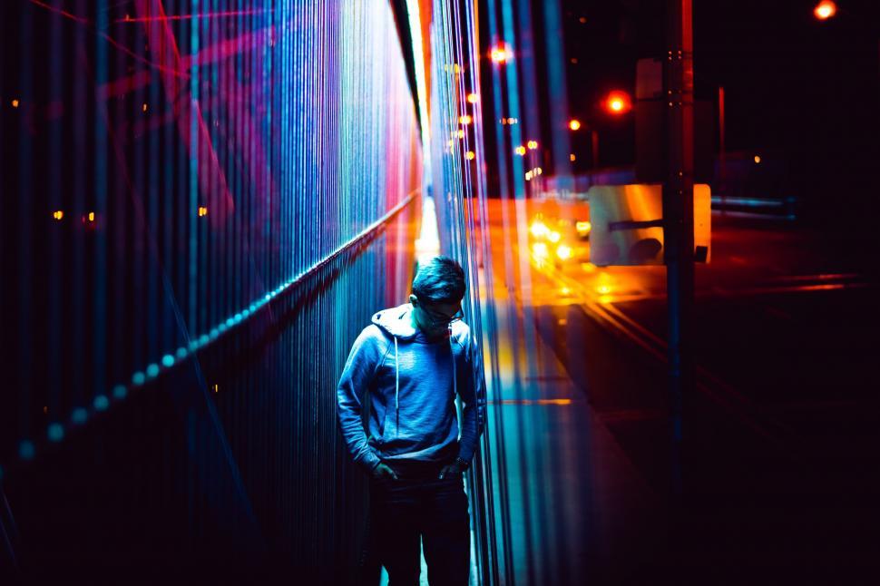 Free Image of Man Standing in Front of Tall Wall 