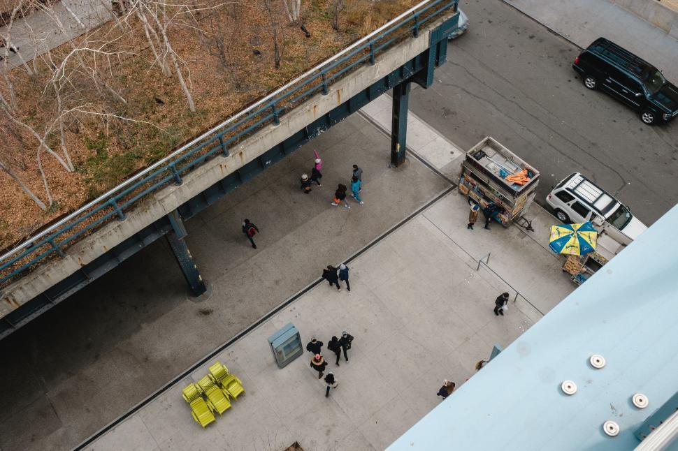 Free Image of Group of People Walking Around Parking Lot 