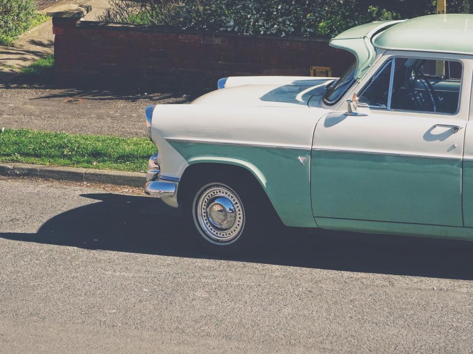 Free Image of Green and White Car in Parking Lot 