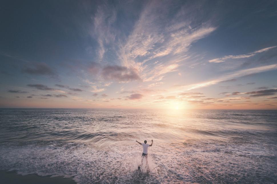 Free Image of Person Standing in Middle of Body of Water 