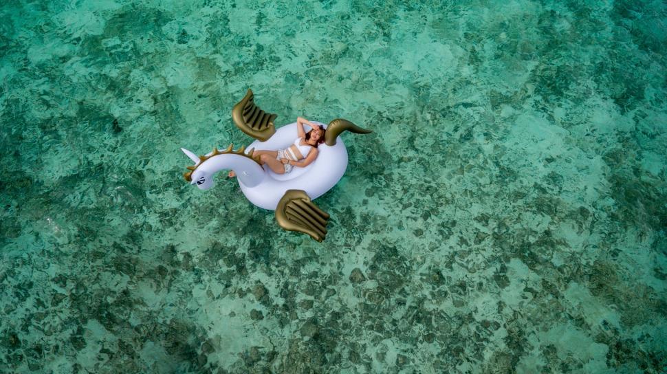 Free Image of Man Riding on Top of White Horse in Ocean 