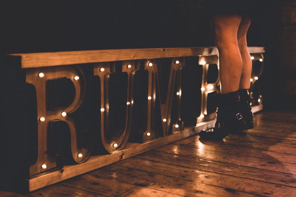 Free Image of Person Standing on Wooden Deck With Lights 