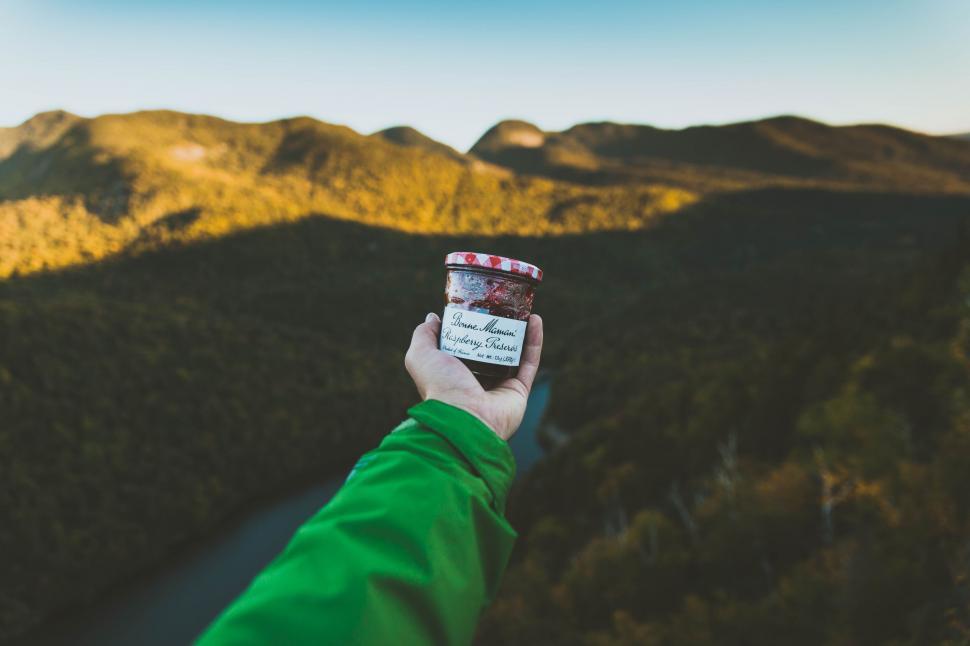 Free Image of Person Holding a Cup of Coffee Up in the Air 