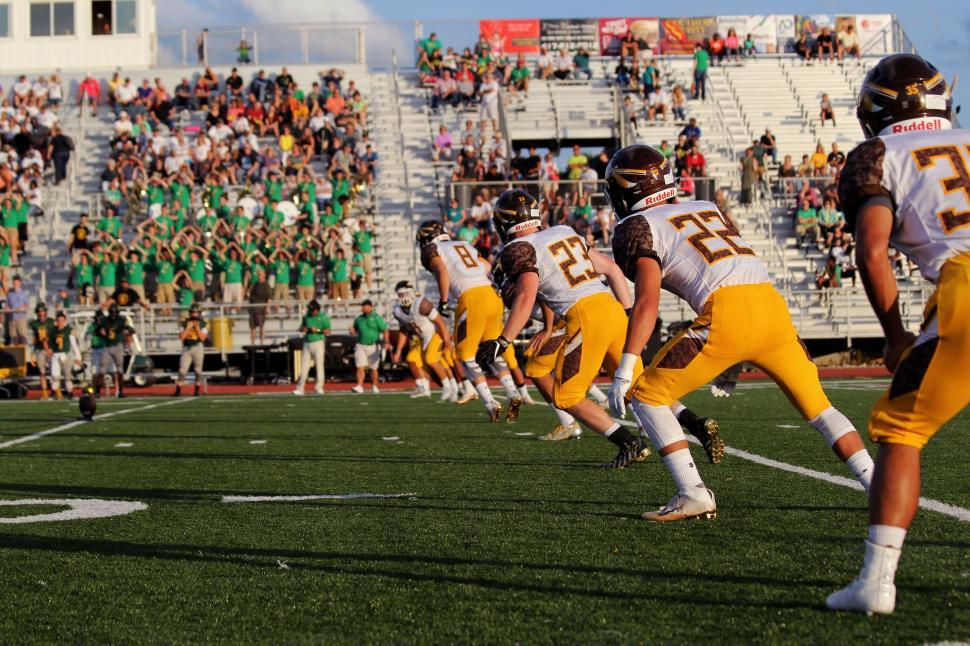 Free Image of Football Players Engaged in Game on Field 