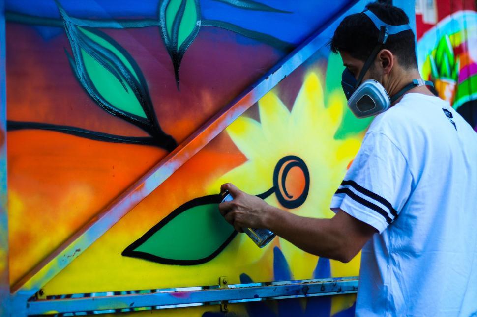 Free Image of Man Painting Mural on Wall 