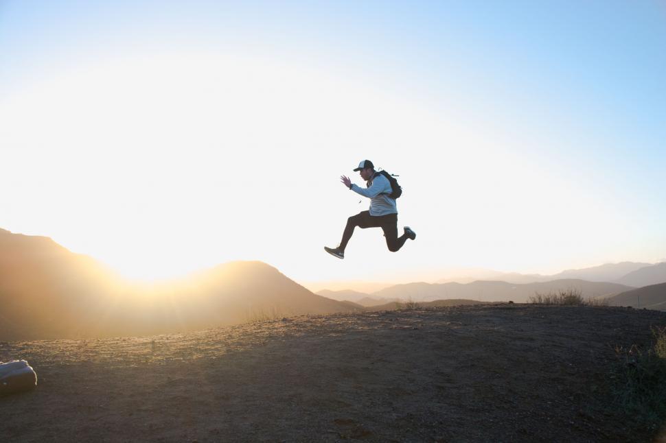 Free Image of Person Jumping in the Air With a Hat On 
