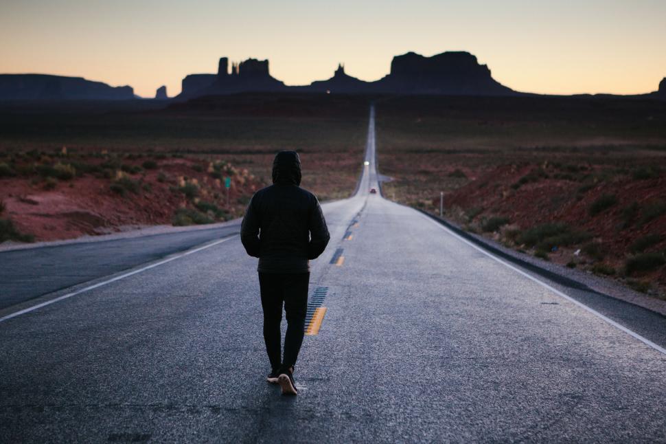 Free Image of Person Walking Down Middle of Road 