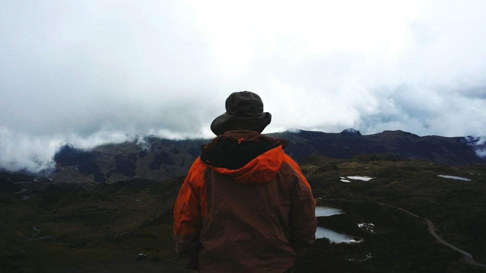 Free Image of Man Standing on Snow Covered Mountain Summit 