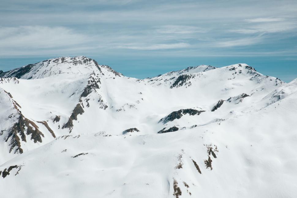 Free Image of Man Skiing Down Snow Covered Mountain 