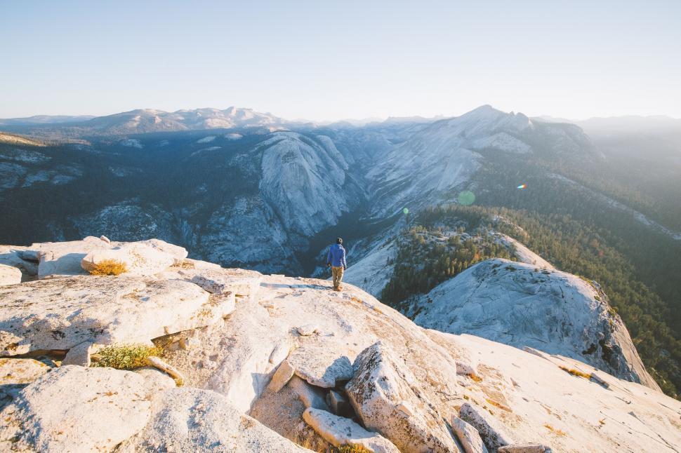 Free Image of Man Standing on Snow Covered Mountain Top 