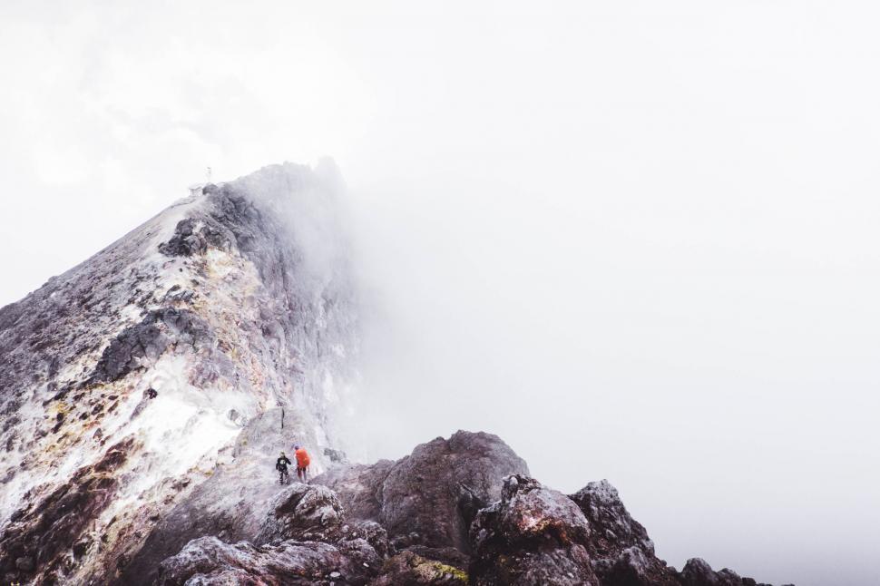 Free Image of Person Standing on Snow-Covered Mountain Summit 