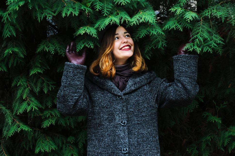 Free Image of Woman Standing in Front of Trees 