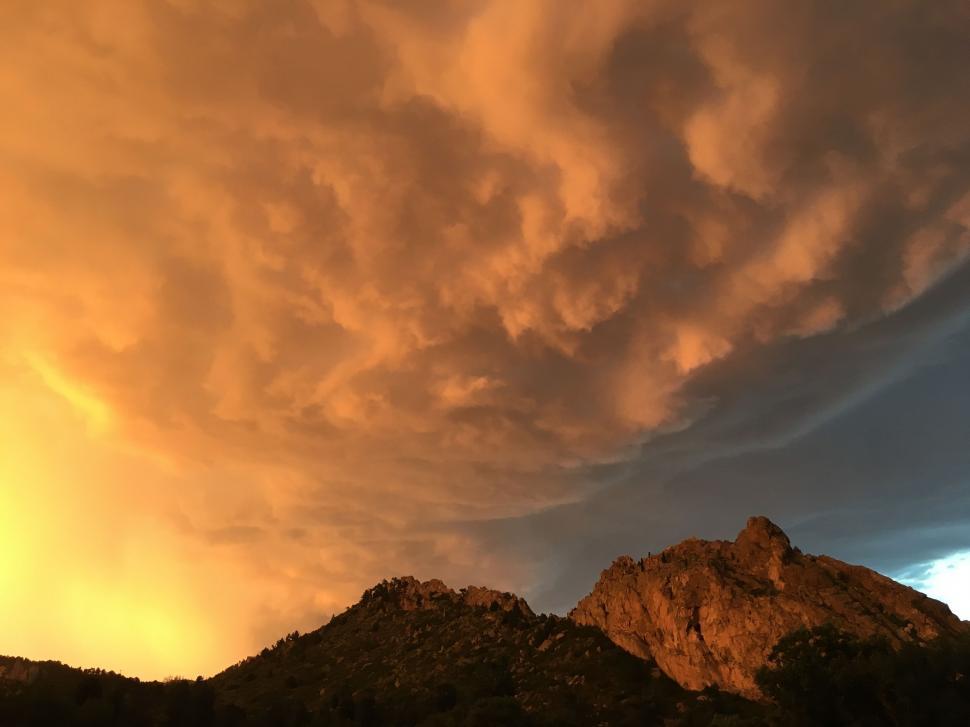 Free Image of Large Cloud Floating Above Mountain 