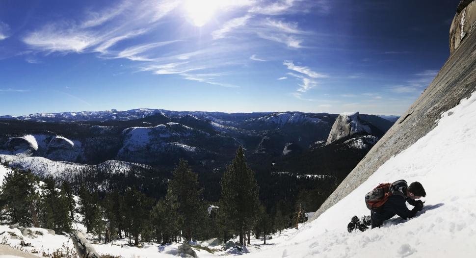 Free Image of Man Riding Snowboard Down Snow Covered Slope 