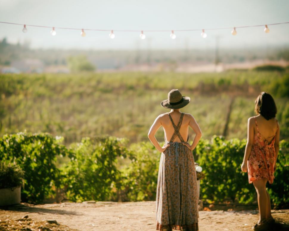 Free Image of Women Standing on Top of Dirt Road 