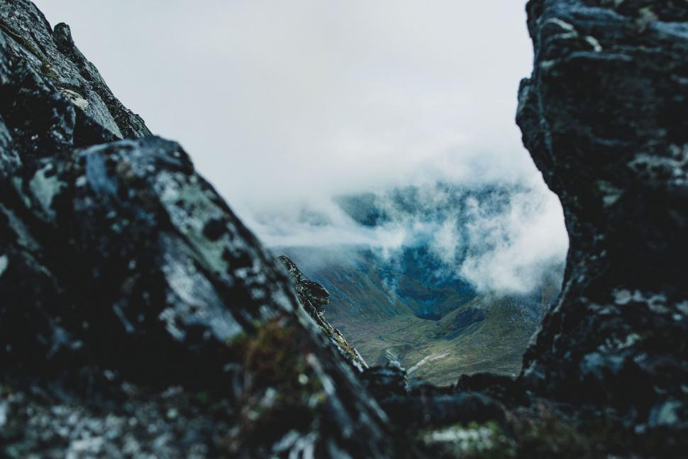 Free Image of Mountain Range View Through Rocks 