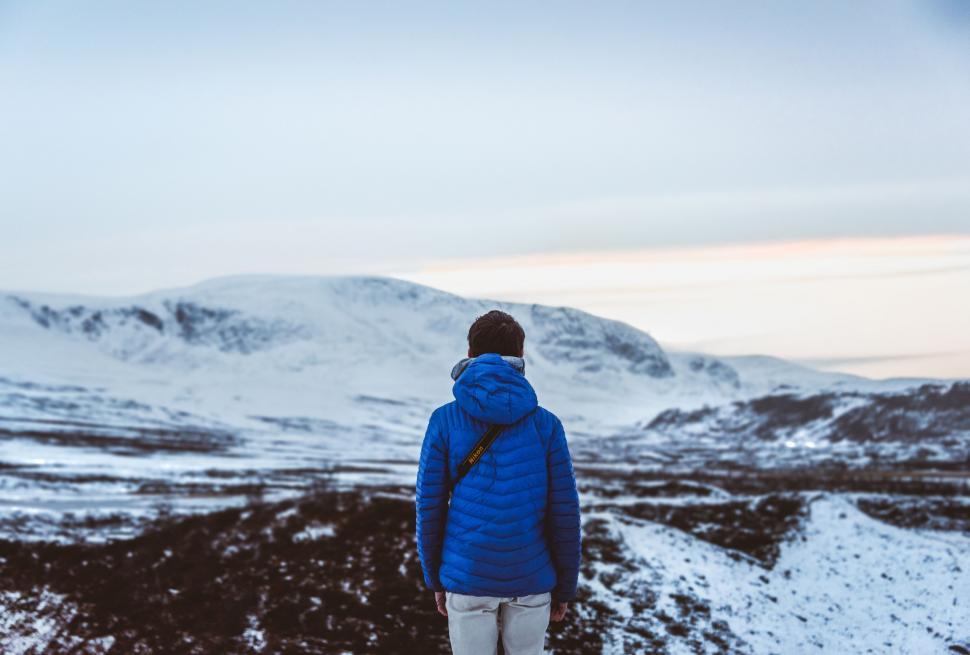 Free Image of Man Standing on Snow Covered Hill 