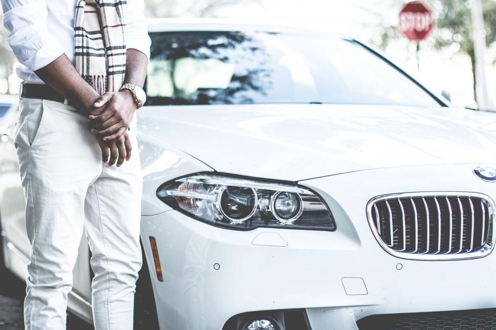 Free Image of Man Standing Next to White Car 