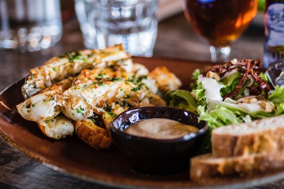 Free Image of Plate of Food and Glass of Beer on Table 