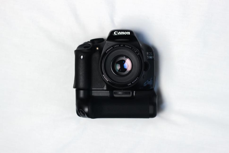 Free Image of Black Camera on White Sheet 