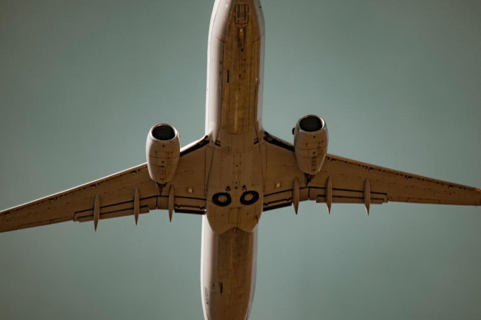Free Image of Large Jetliner Flying Through Blue Sky 