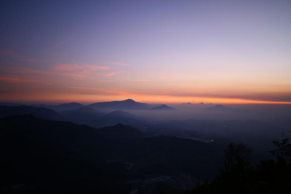 Free Image of Majestic Mountain Range Silhouetted by Sunset 
