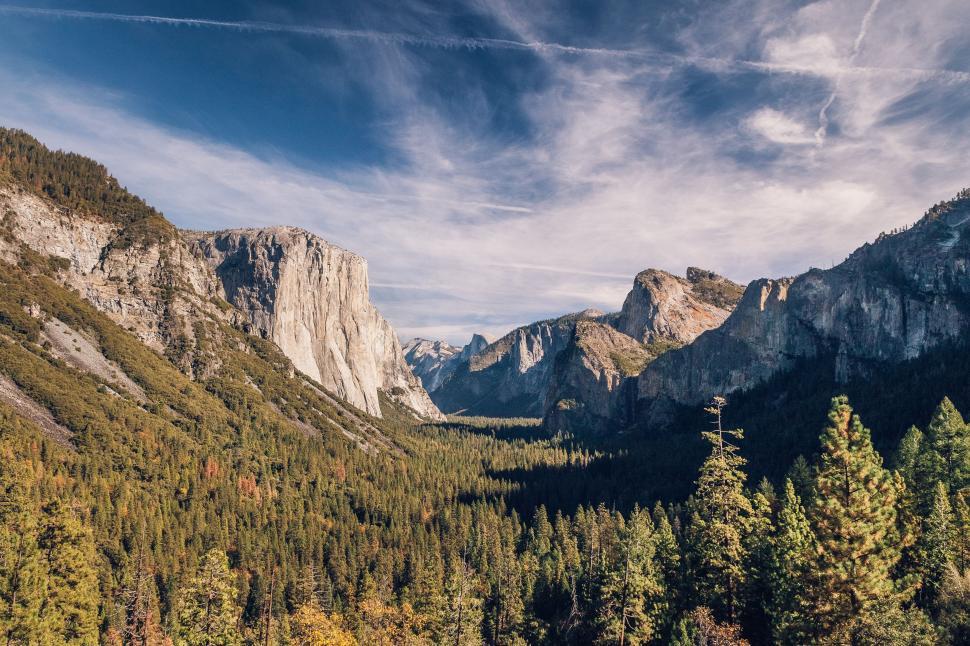 Free Image of Scenic View of Mountain Range With Trees in Foreground 