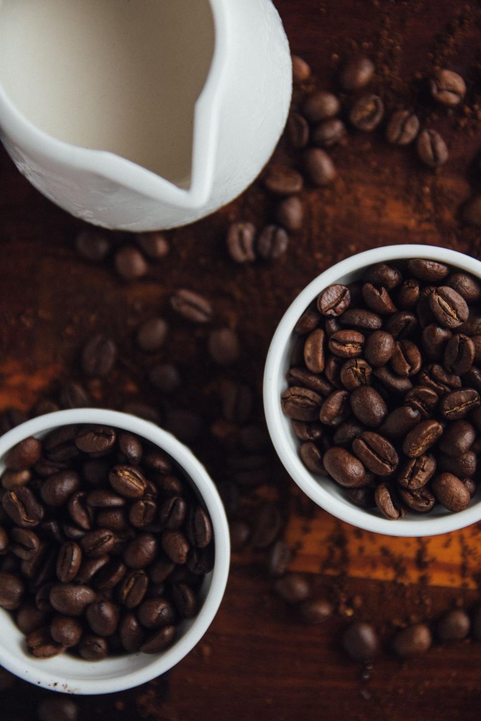 Free Image of Three White Bowls Filled With Coffee Beans on Wooden Table 