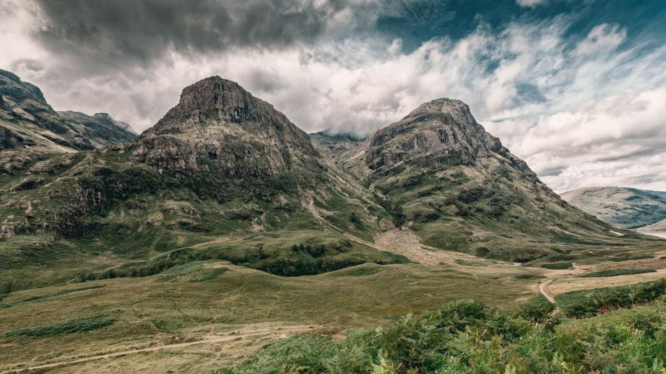 Free Image of Cloudy Sky Above Mountain Range 