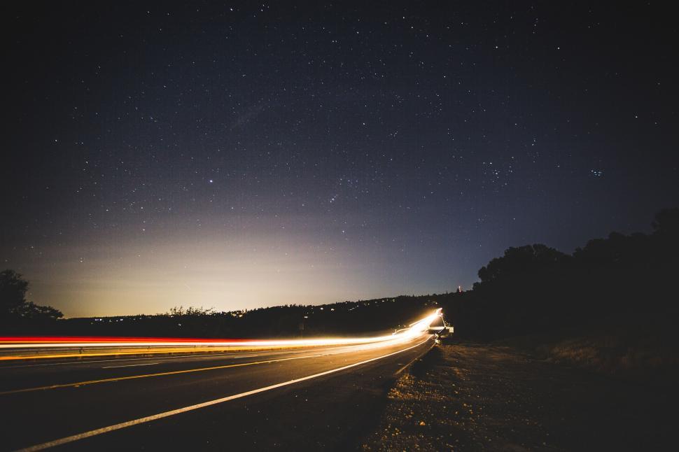 Free Image of Car Driving Down Road at Night 