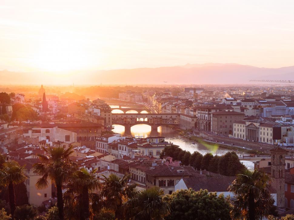 Free Image of Sun Setting Over City With Palm Trees 