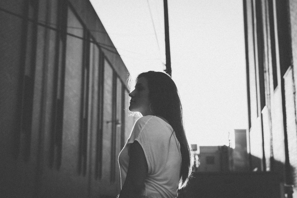 Free Image of Woman Standing in Front of Building 