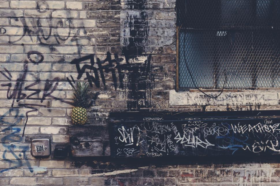 Free Image of Brick Wall With Graffiti and Window 