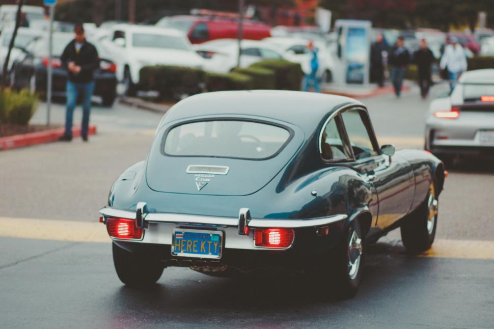Free Image of Vintage Car Driving Down the Street 