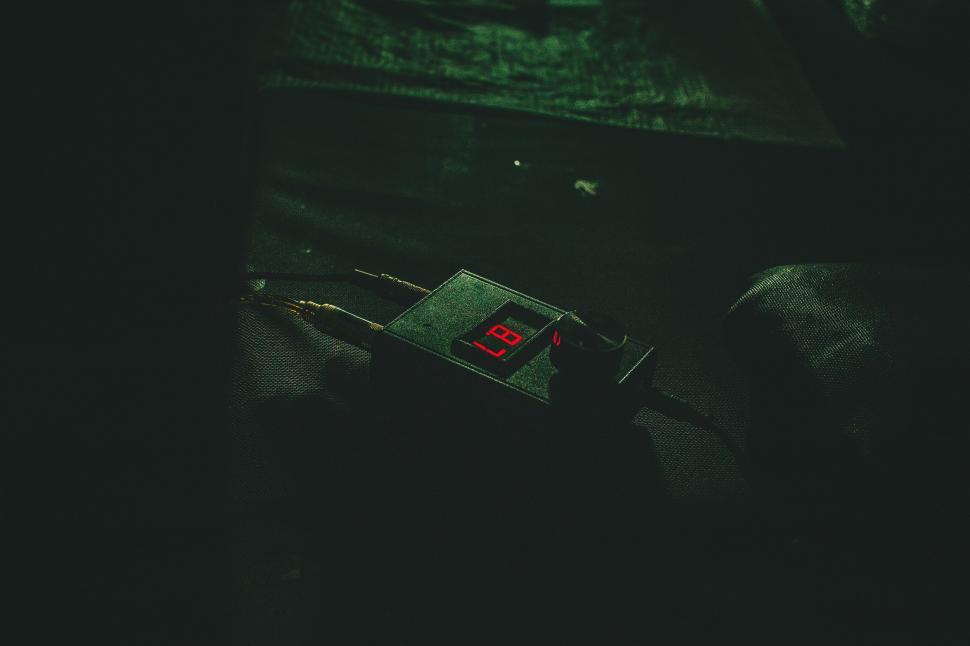 Free Image of Clock on Bed in Dark Room 