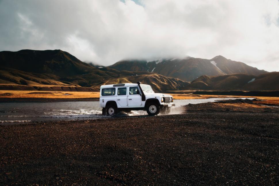 Free Image of White Truck Driving Down Wet Road 
