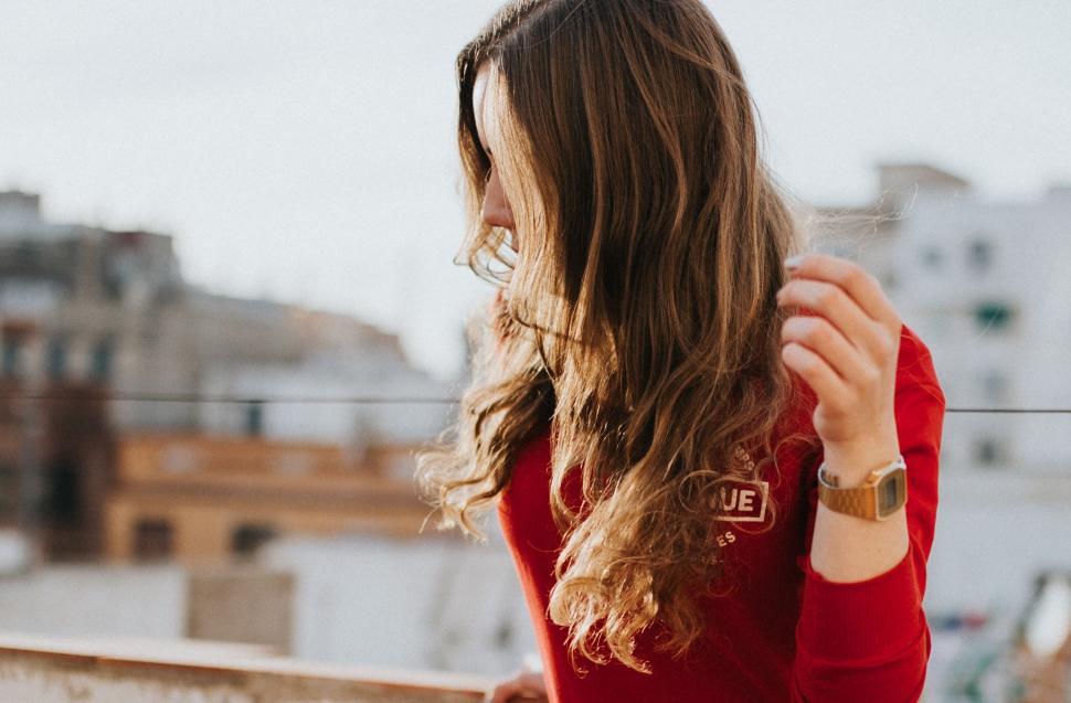 Free Image of Woman in Red Shirt Standing on Balcony 