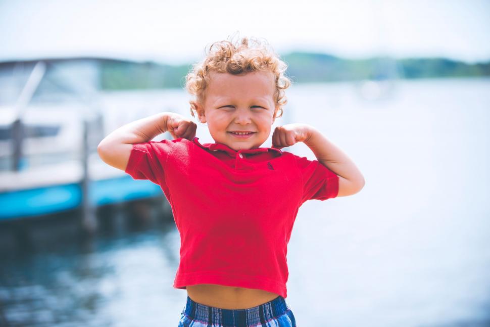 Free Image of Young Boy Standing by Waters Edge 