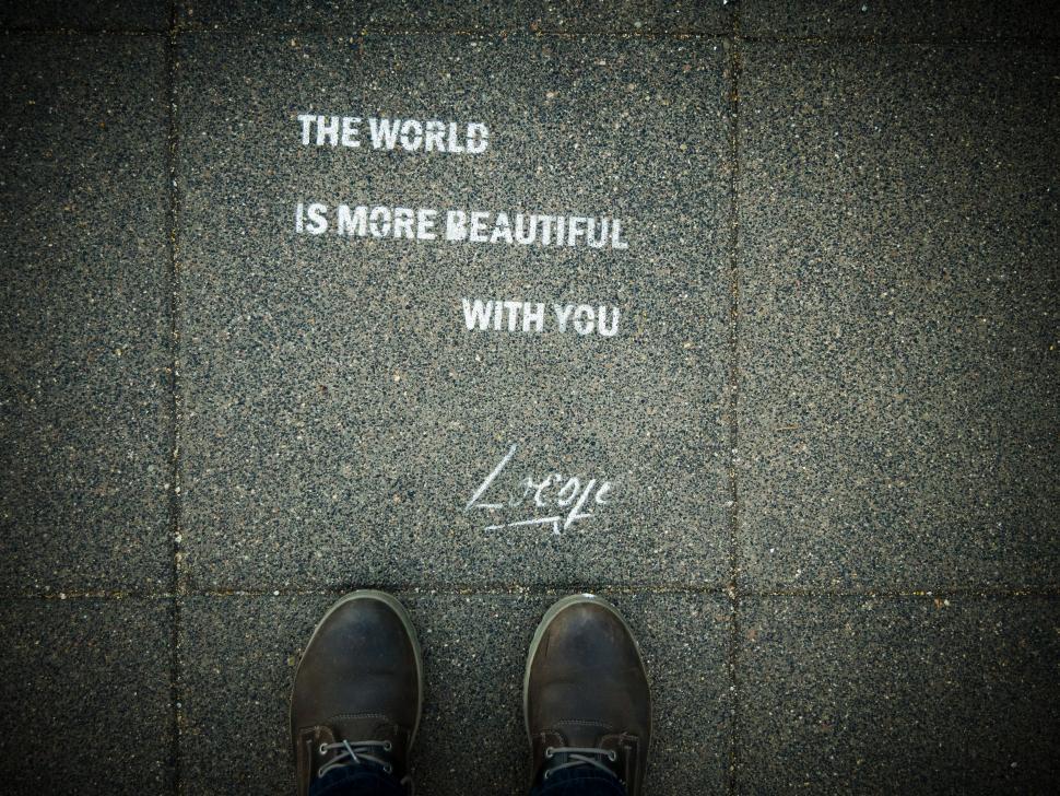 Free Image of Pair of Shoes Resting on Sidewalk 